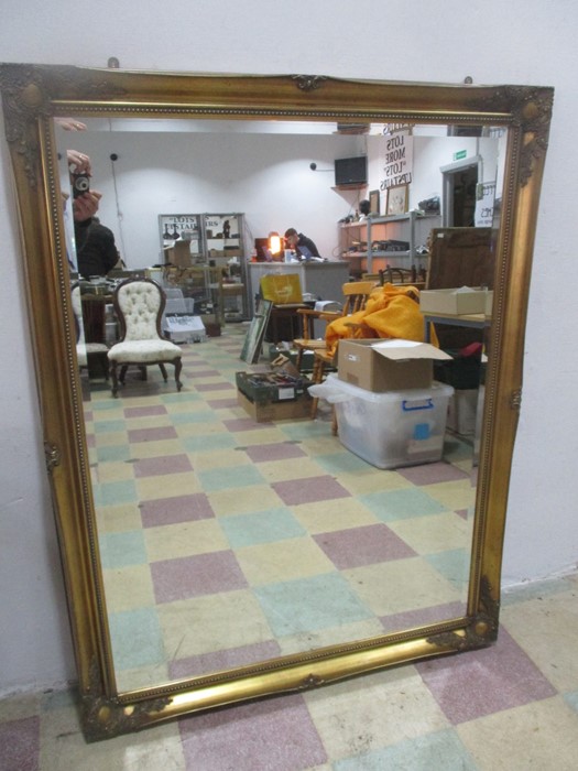 A large gilt mirror, 138cm x 106 cm