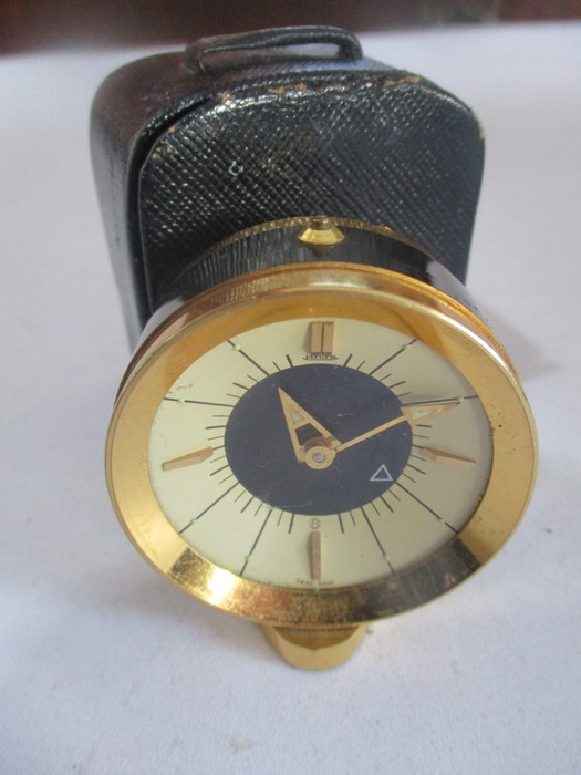 A Jaeger travel alarm clock ( stamped 73 to base) in leather case- case A/F