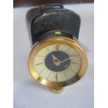 A Jaeger travel alarm clock ( stamped 73 to base) in leather case- case A/F