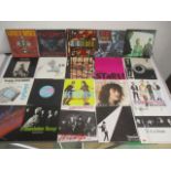 A collection of 1980's 7" vinyl singles including Bruce Stringsteen, Wham, The Jam, Guns N'Roses,