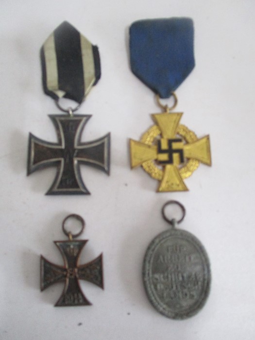 A WWI Iron Cross ( 1914), a German 40 year service medal, West Wall medal and a Brunswick war