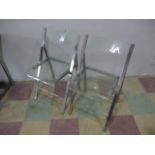A pair of perspex folding chairs with chrome frames