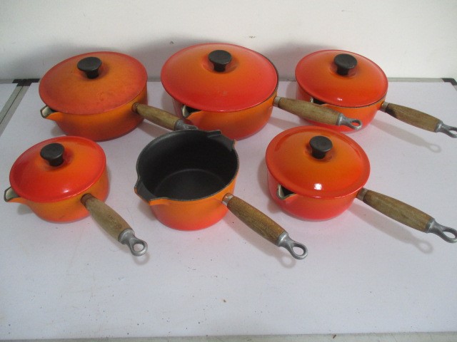 A collection of vintage Le Creuset saucepans