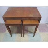 A mid century teak nest of tables