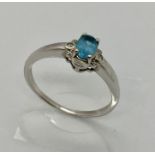 A 9ct white gold dress ring set with blue stone and diamonds - 1.8g Size P