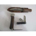 A WWII pocket knife with broad arrow stamp dated 1945, a trench knife in leather scabbard along with
