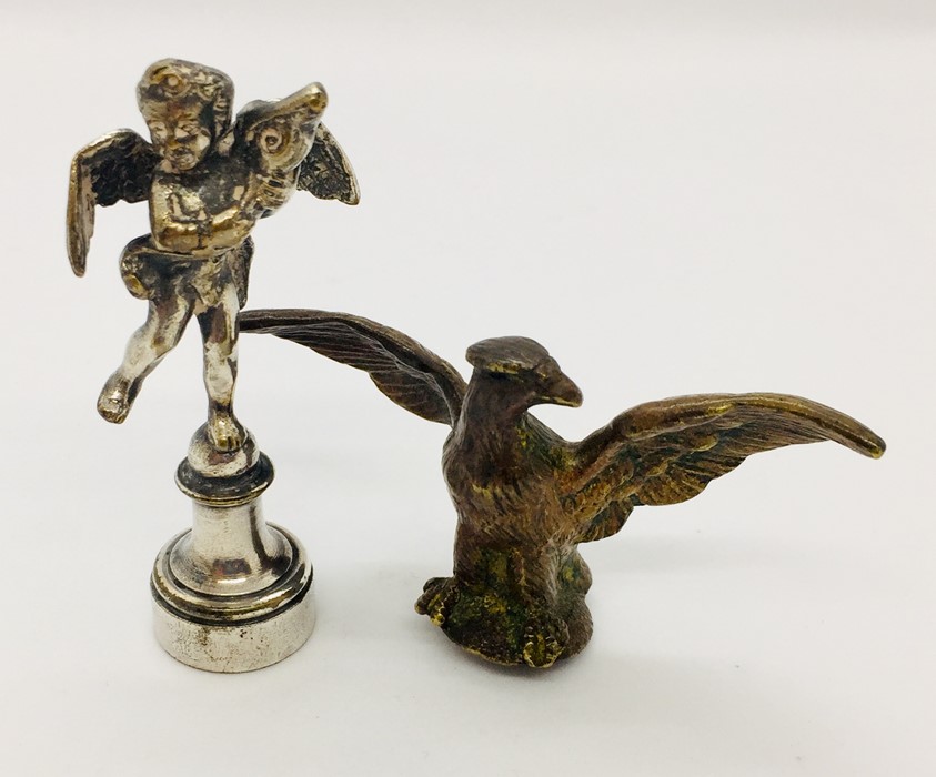 A silver plated seal with cherub and bronze eagle finial.