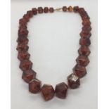 A faceted amber necklace circa 1970 with a 9 ct gold "coffee bean" clasp- total weight 196g