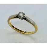 An 18ct gold and platinum diamond solitaire ring, size M
