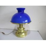 A reproduction brass ships lamp (S.S Grand River, Saint Louis) with blue glass shade