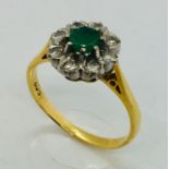 An 18ct gold emerald and diamond cluster ring, size M