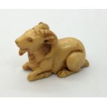 A signed netsuke of a recumbent ram.