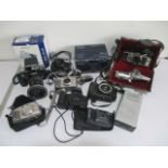 A collection of various cameras including Sony, Canon, Minolta, Bell & Howell etc