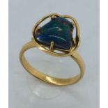 A 9 ct gold ring set with an irregular shaped black opal, size N