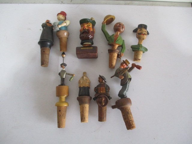 A collection of vintage wooden bottle stoppers including Anri