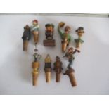 A collection of vintage wooden bottle stoppers including Anri