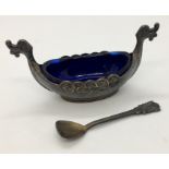 A sterling silver Norwegian salt in the form of a Viking long boat, with spoon.
