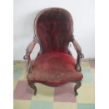 A Victorian upholstered button back arm chair