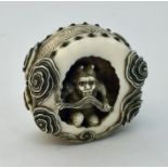 A signed 19th century carved netsuke of an Oni in a cave