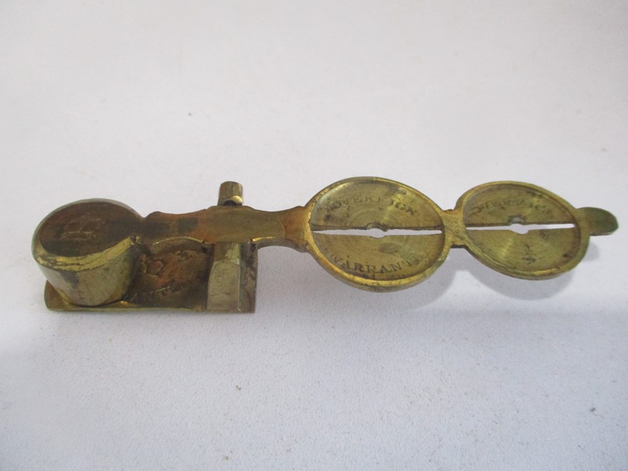 A brass sovereign scale