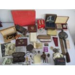 A collection of various interesting items including Hohner harmonica, coins, cigarette cases,