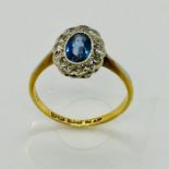 An 18ct gold and platinum cornflower blue sapphire and diamond cluster, size L