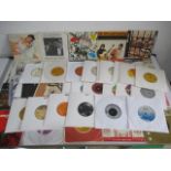 A collection of 7" vinyl records including David Bowie, Carly Simon, Deep Purple, The Who, Elton