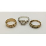 A 9ct gold wedding band along with one other and a silver dress ring (gold weight 6.9g)
