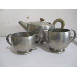 A Tudric, for Liberty & Co hammered pewter tea set- tea pot dented