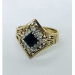 A 9 ct gold sapphire and CZ ring in an Egyptian style, size N1/2