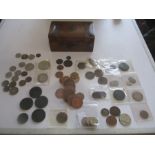 A collection of various coins in a Victorian money box
