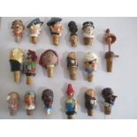 A collection of vintage bottle stoppers/ pourers including novelty articulated versions