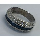 An 18ct white gold diamond and sapphire dress ring, total weight 5.8g, Size M