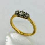An 18ct diamond three stone ring, size K