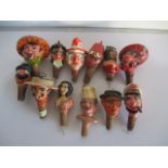 A collection of vintage novelty bottle stoppers including one musical.