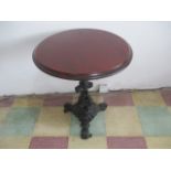 A pub table on cast iron base with stylised dolphins