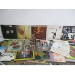 A collection of LPs including David Bowie, Wishbone Ash, Genesis, Rolling Stones etc