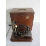 A wooden cased Wilcox & Gibbs sewing machine