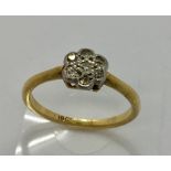 An 18ct gold daisy ring set with diamonds, size J 1/2