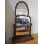 A Victorian toilet mirror along with an Edwardian oval wall mirror