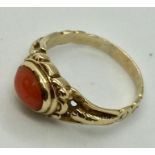 An unmarked gold (probably 14ct) ring set with coral. Size M1/2
