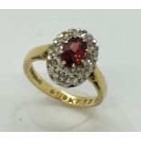 An 18ct gold garnet and diamond cluster