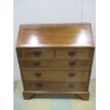 A Georgian style bureau with bracket feet