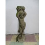 A concrete bird bath base with cherub