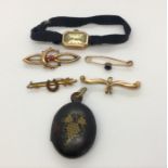 Four 9ct gold sweetheart brooches (Total weight 5.3g) along with a 9ct gold cocktail watch and an