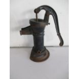 A vintage cast iron water pump