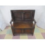 An oak Monks bench with bobbin turned pillars.