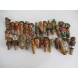 A collection of vintage novelty wooden bottle stoppers including some mechanical.