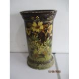 An antique hand painted pottery stick stand with floral decoration