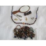 A small collection of costume jewellery along with a 925 silver spoon, whistle, hand mirror etc.